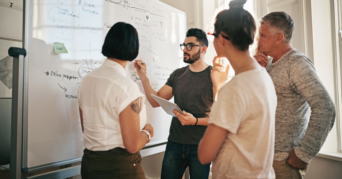 A group of people discussing the different types of SEO